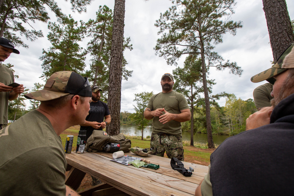 Tyr Symank teaches attendees Tactical Combat Casualty Care for advanced safety in the woods. Photo by Nichole Scaraglino.
